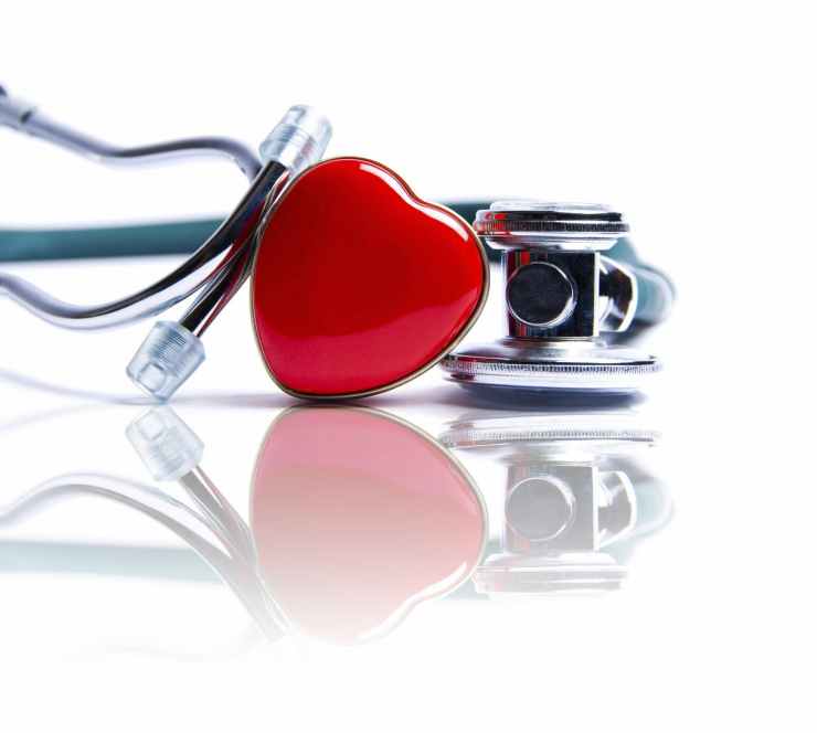 A picture of a stethoscope with a shiny red heart attached to it.